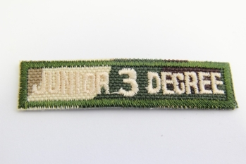 0303/15/415/54 - Emblem , Polyester, ca. 57x 14 mm , grün/ beige